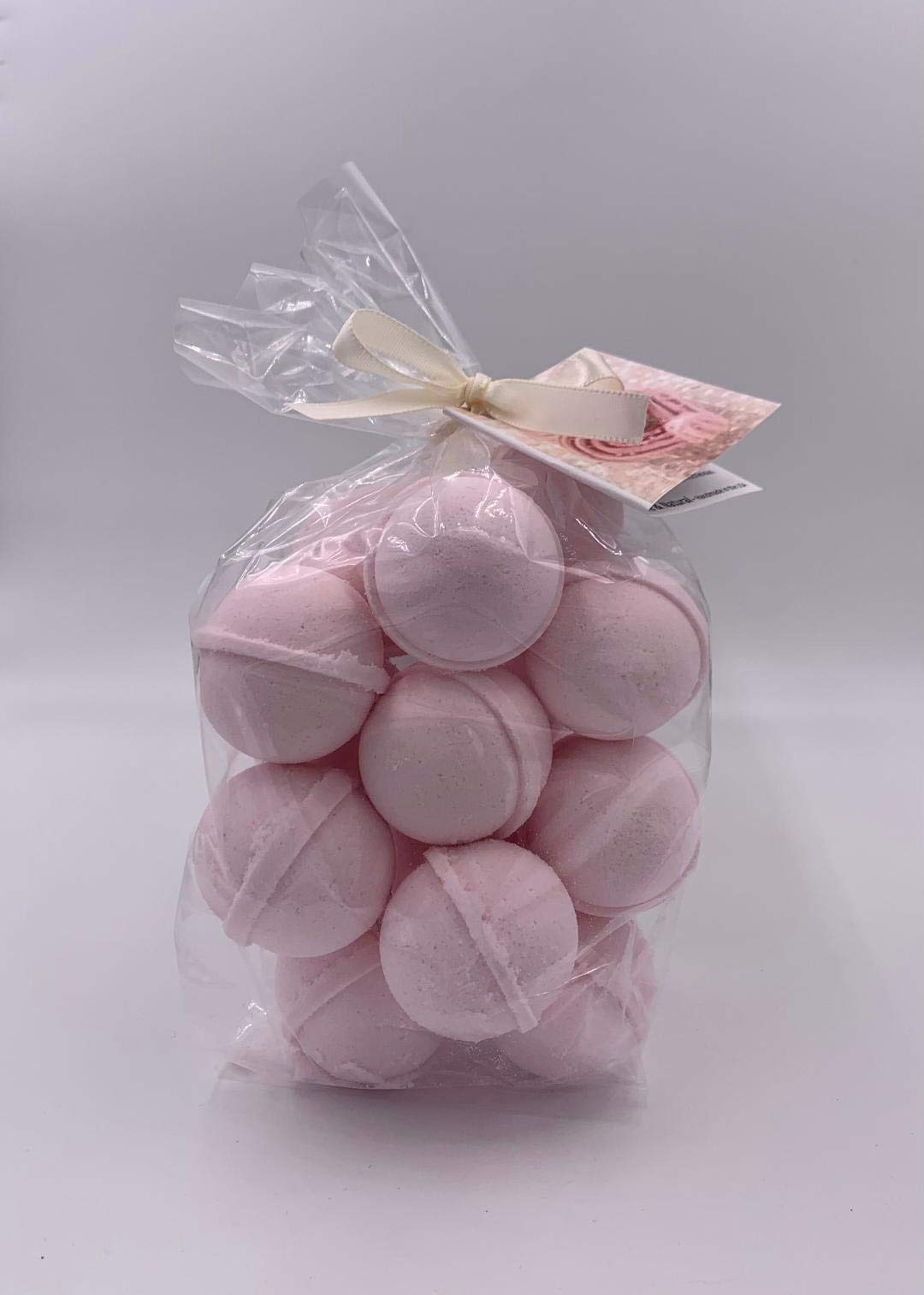 Spa Pure Pink Sugar Bath Bomb melting in water, releasing aroma for relaxation.
