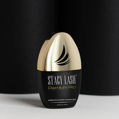 STACY LASH Premium Pro glue bottle in a lash kit display signals salon-ready performance.