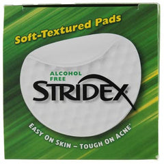 Stridex pad in hand applying across jawline for broad cleaning.