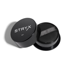 Stryx Anti-Shine Powder compact with built-in sponge for quick touch-ups.