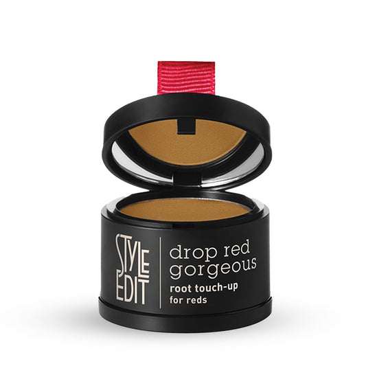 Precision sponge applying Style Edit powder to light red roots.
