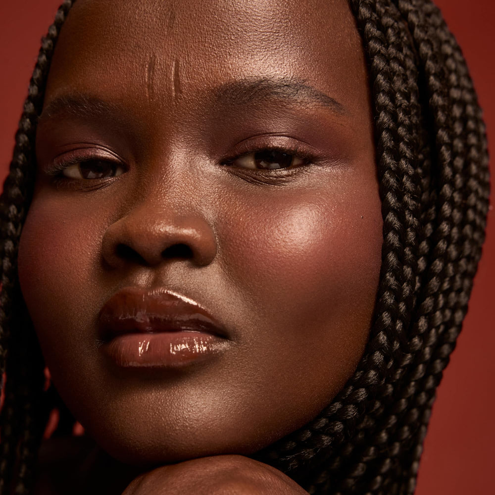 Packaging highlights the nine-oil blend and Vitamin E for nourished lips.