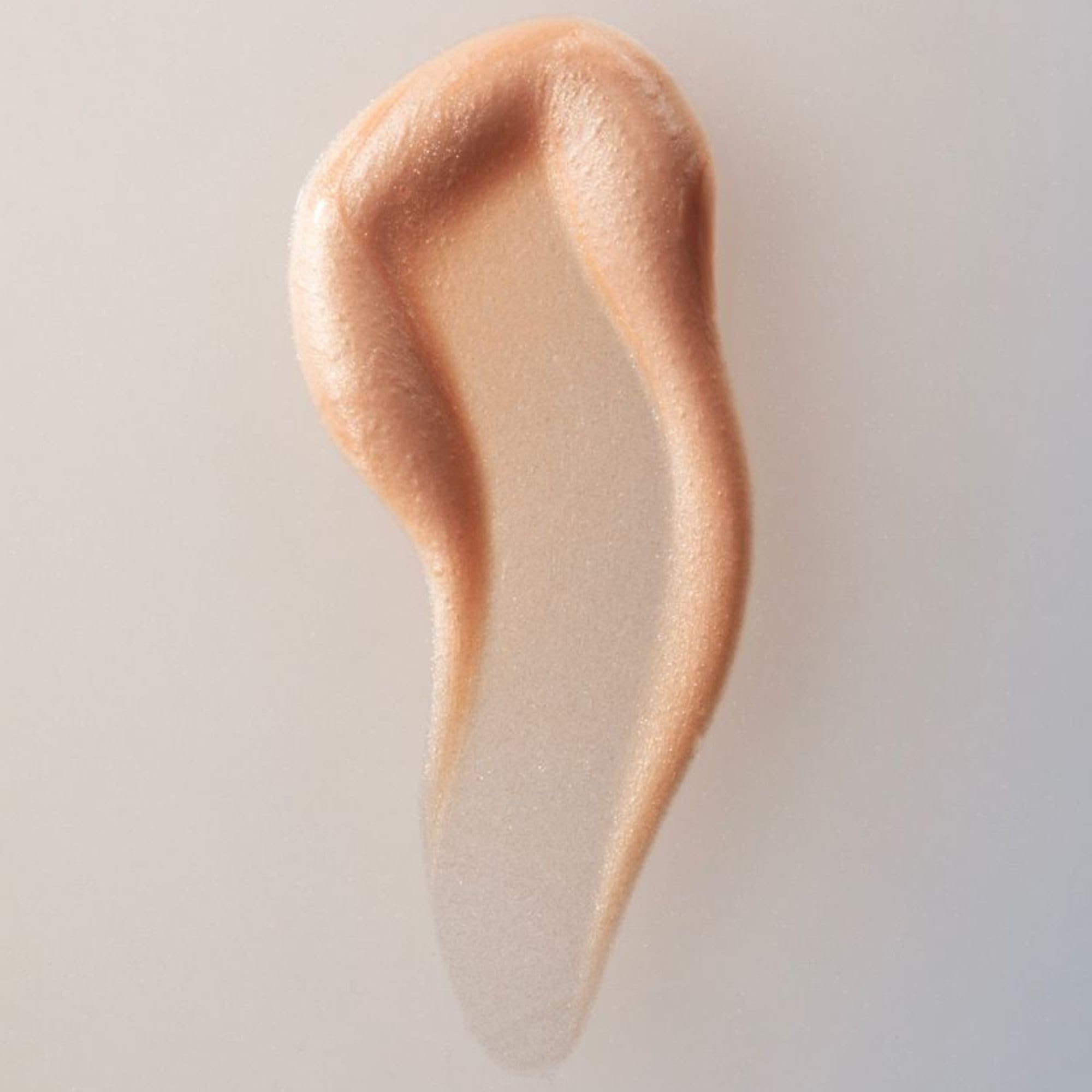 Summer Fridays Illuminating Drops dropper releasing a lightweight serum.