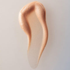 Summer Fridays Illuminating Drops dropper releasing a lightweight serum.