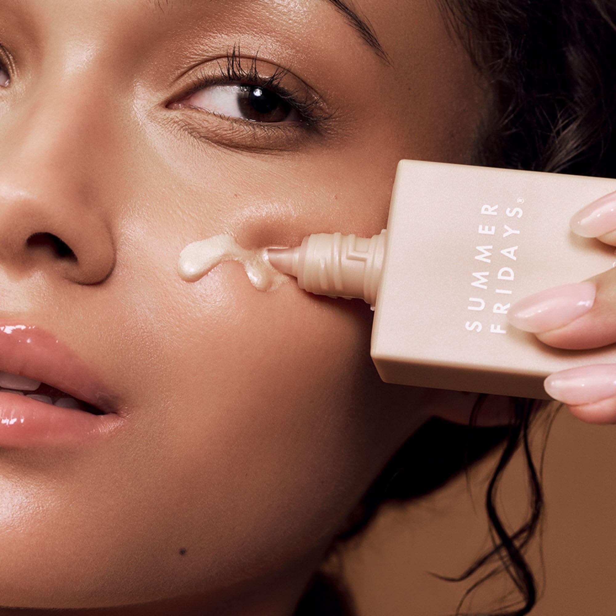 Summer Fridays Illuminating Drops applied on skin for a soft glow.
