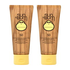 Sun Bum Original SPF 50 sunscreen lotion bottle safeguards skin at the beach.
