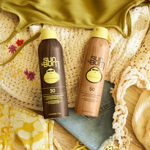 Sun Bum Original spray applied to hands for easy sun protection.