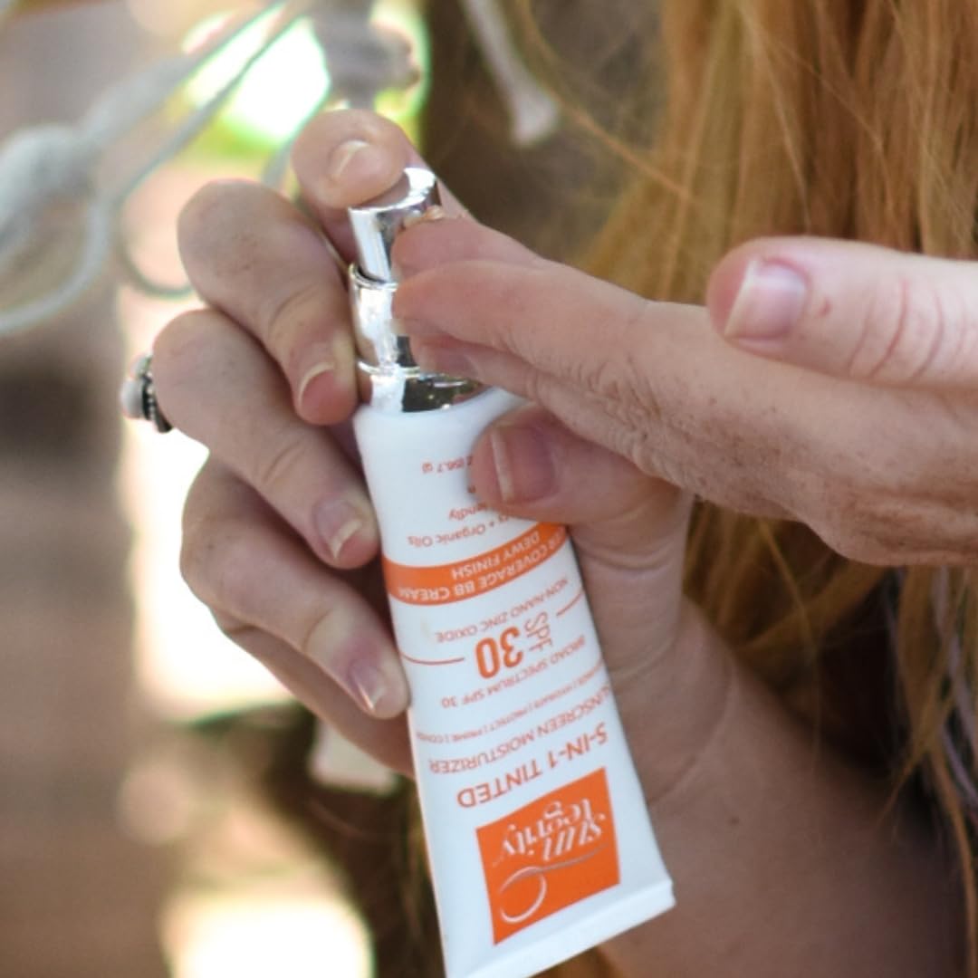 Dermascope award badge beside Suntegrity tinted sunscreen packaging.