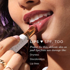 Closeup of TATCHA Kissu Lip Tint Midnight Lily tube and texture