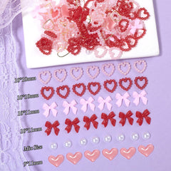 Tatiwoo pink-red heart charms create romantic focal points for nails.