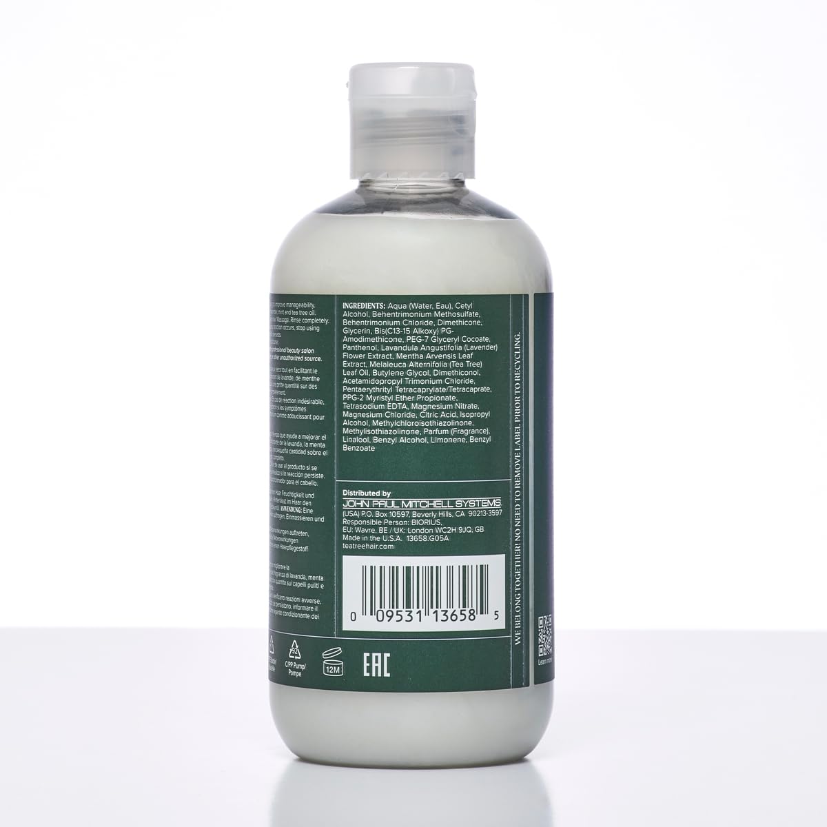 Lavender sprigs beside Tea Tree Lavender Mint conditioner for calming fragrance.
