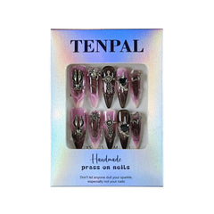 Close-up view of intricate charms and nail art by TENPAL