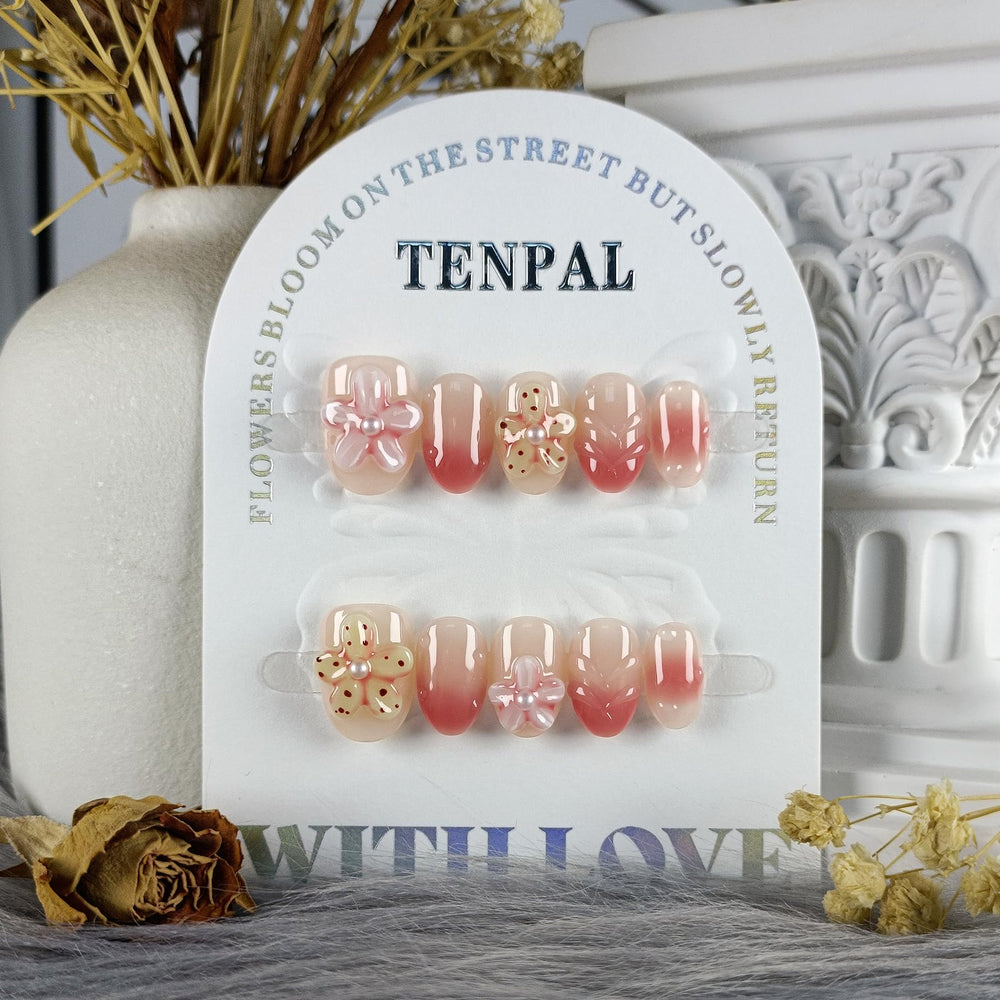 TENPAL hand-sculpted flowers detail on nails for elegant style.