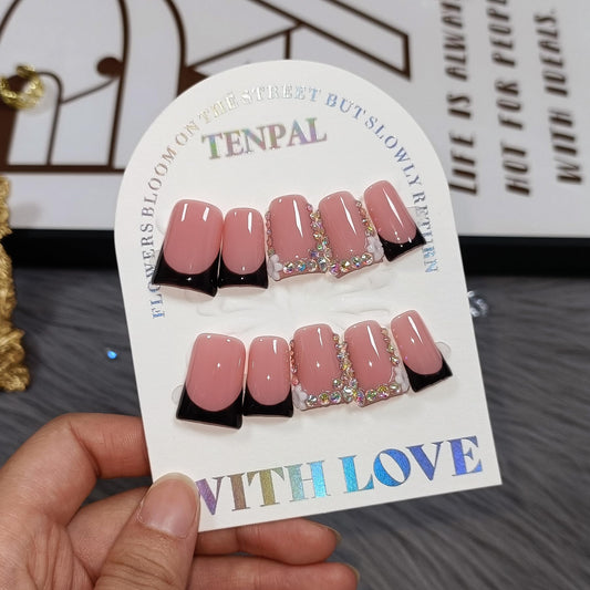 TENPAL handmade duckbill nails in pink and black French tip with rhinestone edge for a glamorous at-home manicure.