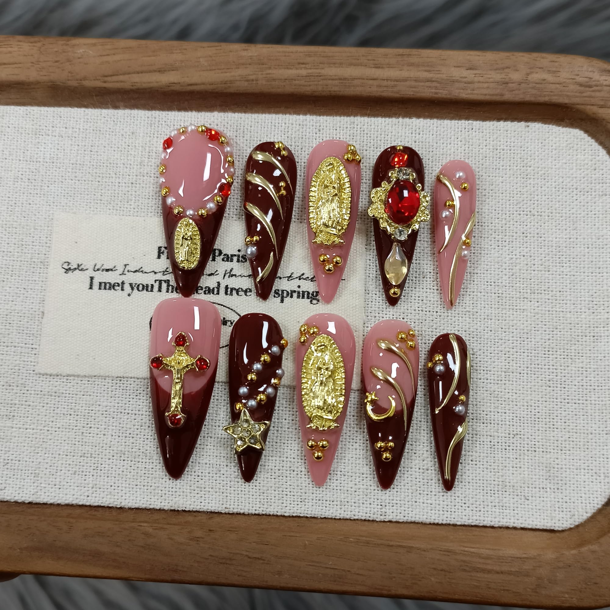 TENPAL handmade press-on nails in long stiletto shape with nude pink wine cross design.