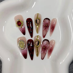 TENPAL long-stiletto nails showcase burgundy gloss and cat-eye shimmer