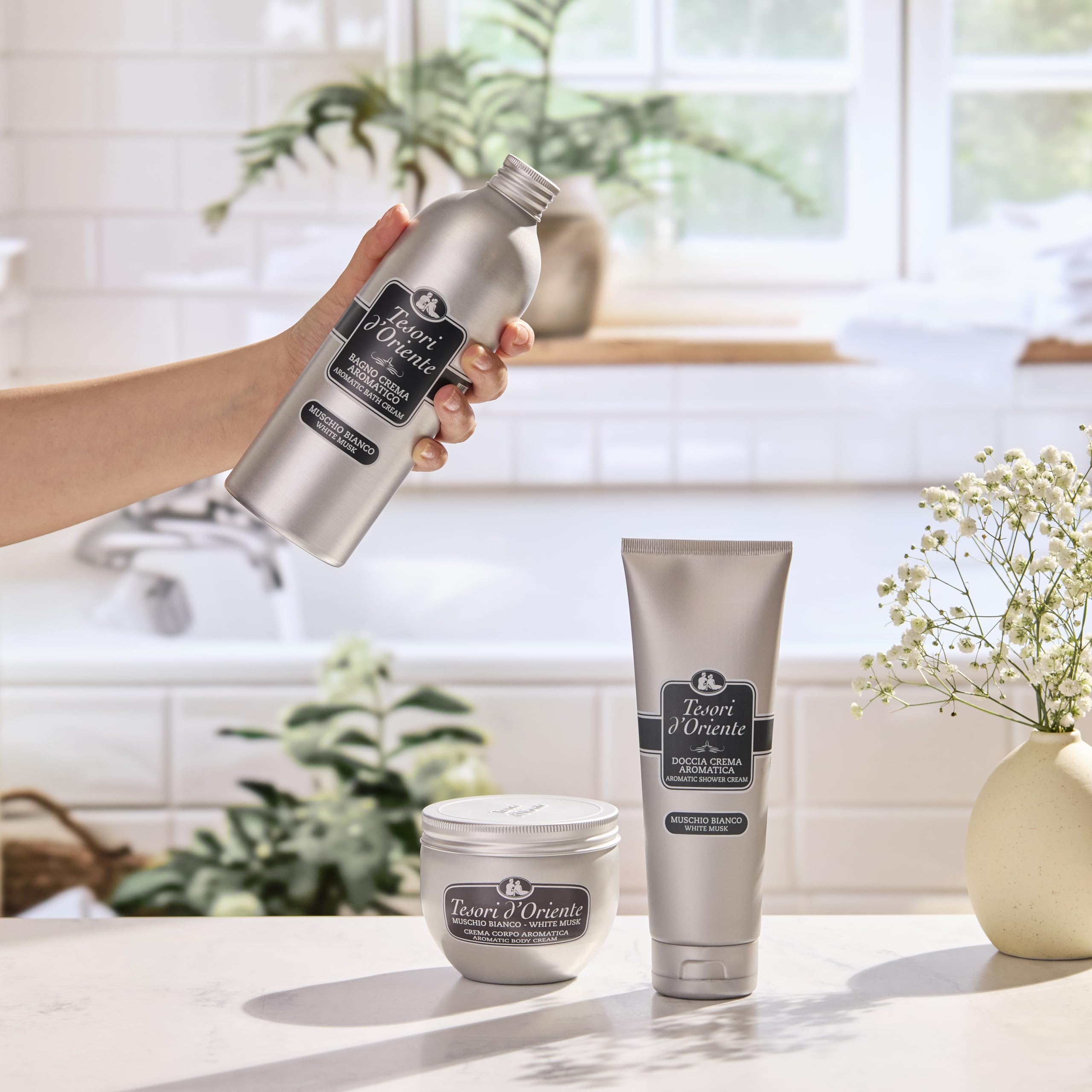 Applying Tesori d'Oriente body cream to skin for daily hydration.