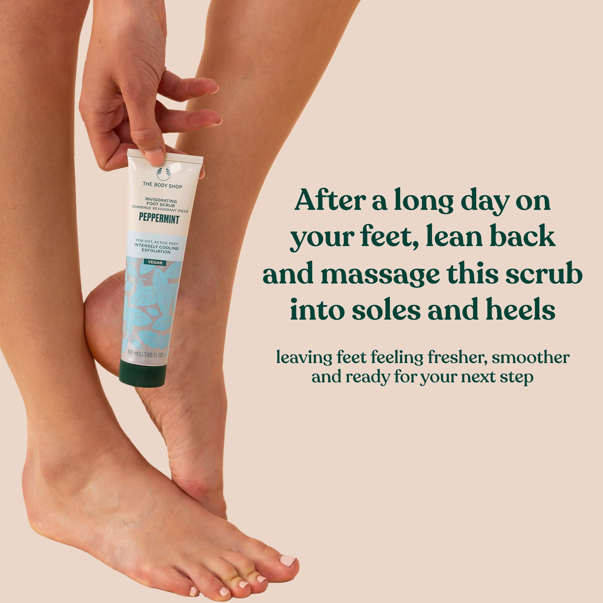 Close-up of rough feet being smoothed with The Body Shop Peppermint Invigorating Foot Scrub.