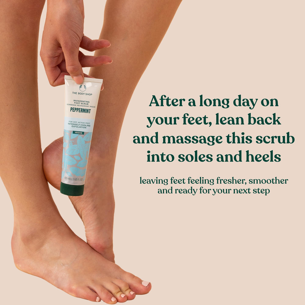 Close-up of rough feet being smoothed with The Body Shop Peppermint Invigorating Foot Scrub.