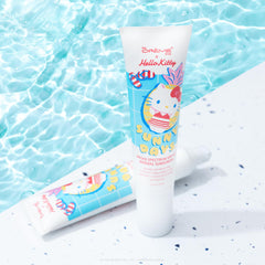 Applying The Crème Shop sunscreen on the face for daily wear.