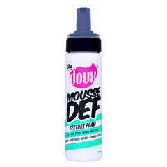 The Doux Mousse bottle-application demonstrates even distribution for defined curls.
