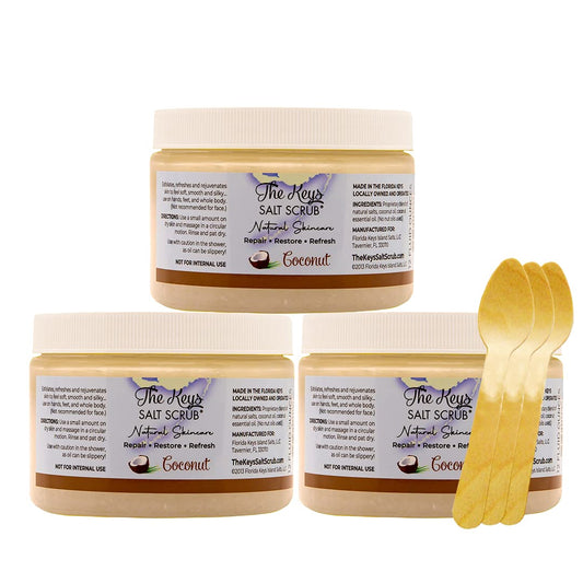 The Keys Salt Scrub coconut sea salt scrub with wooden spoon for smooth, hydrated skin.