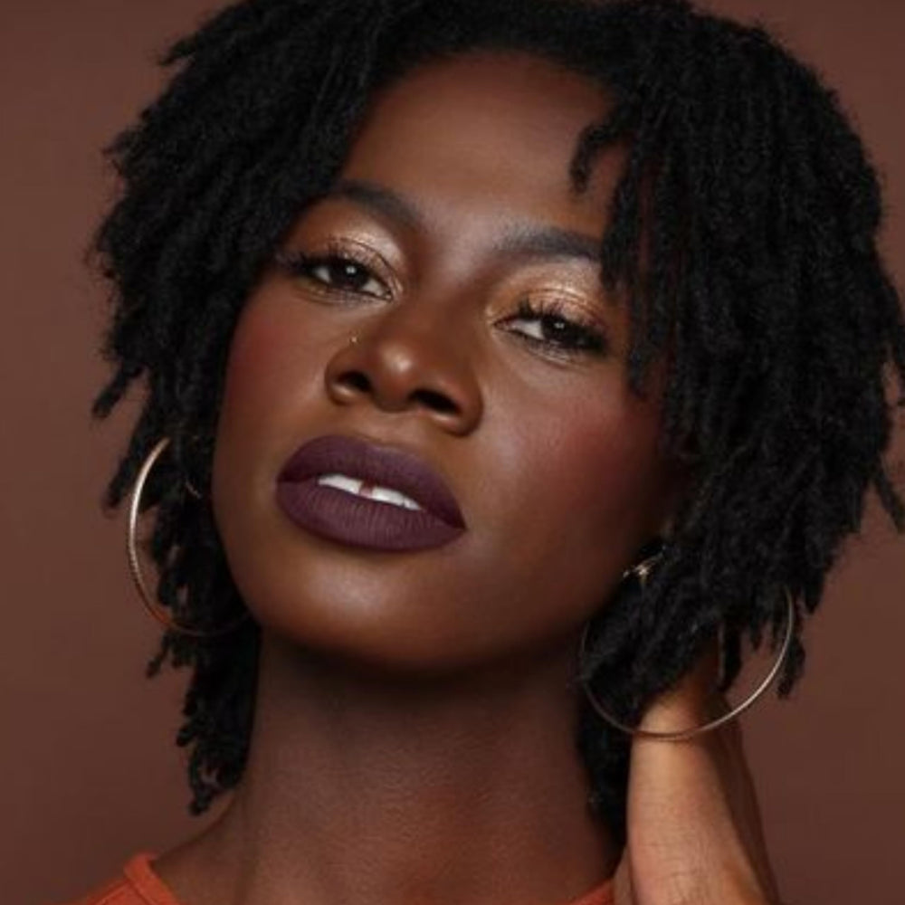 Close up of Drama Queen liquid texture gliding onto lips for even coverage.