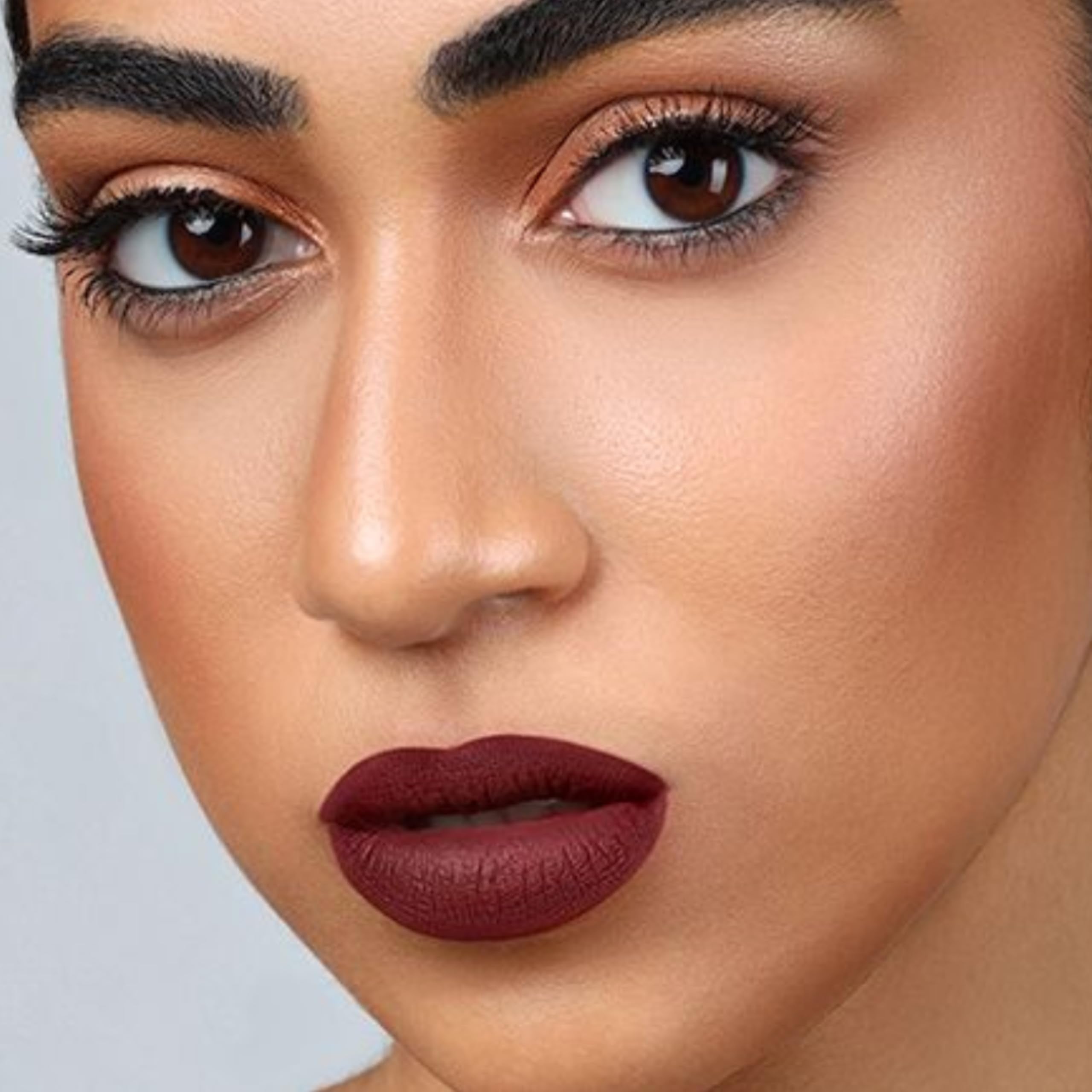 The Lip Bar shade application on lips shows even saturation and depth.