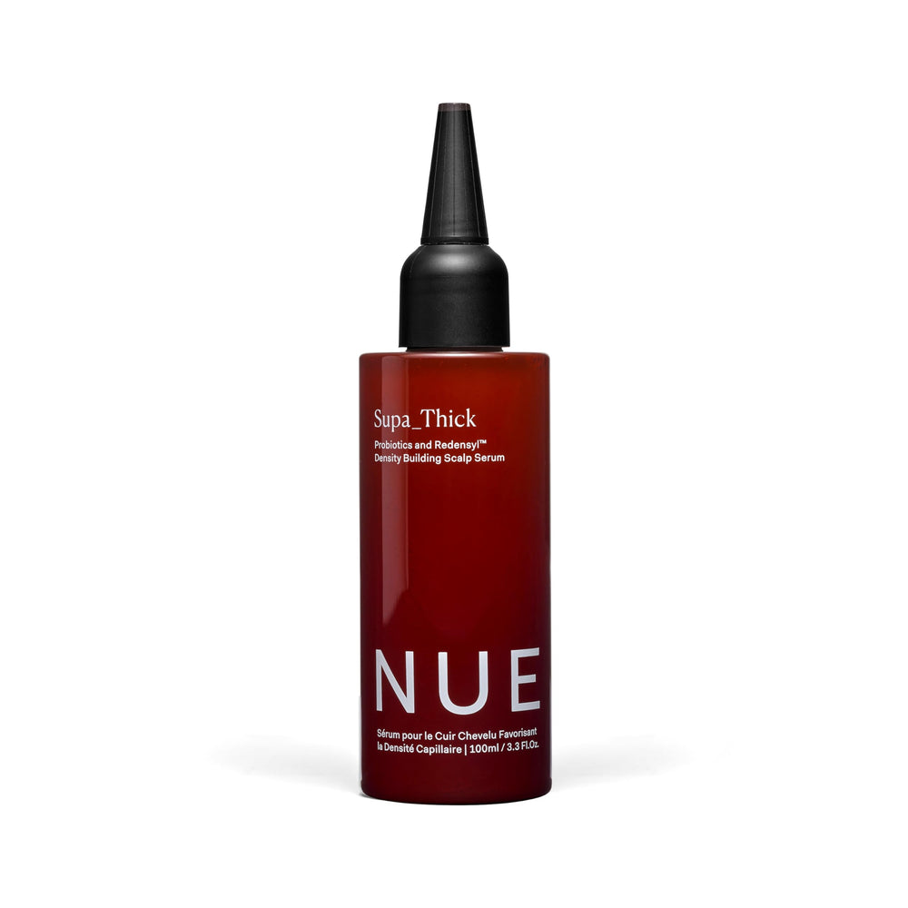 The Nue Co Supa Thick Hair Serum bottle close-up for a lightweight, refreshing scalp treatment.