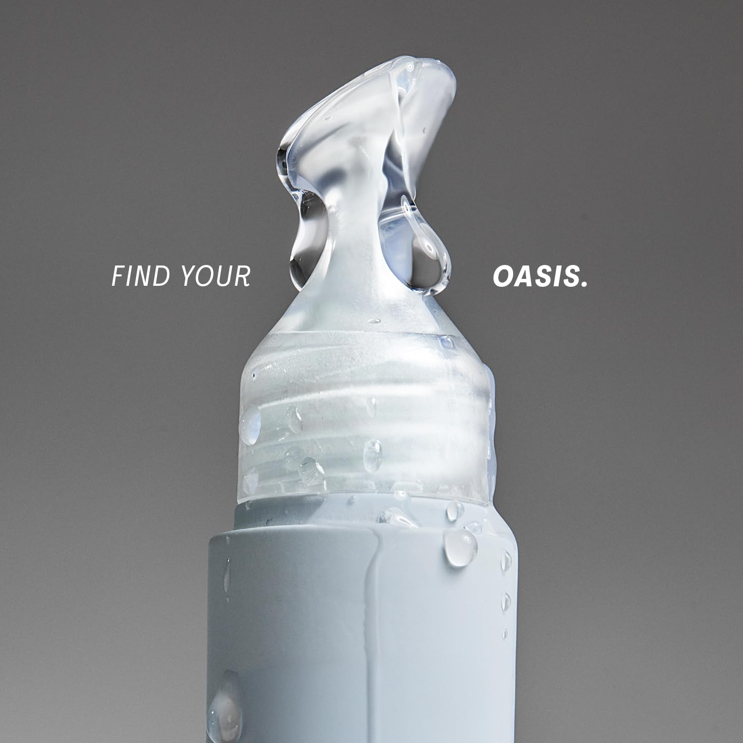 The Outset Lip Oasis clear gloss bottle shows a sleek, glassy finish for everyday wear.