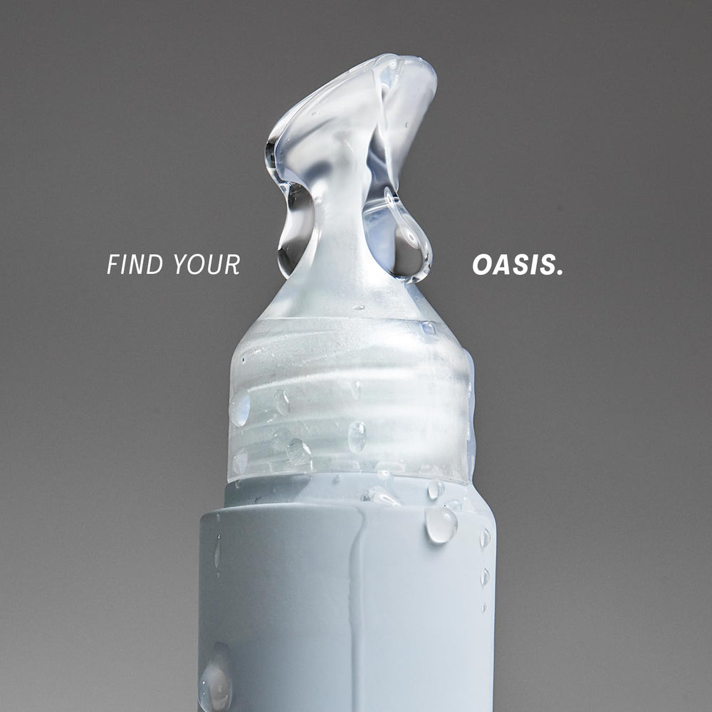 The Outset Lip Oasis clear gloss bottle shows a sleek, glassy finish for everyday wear.