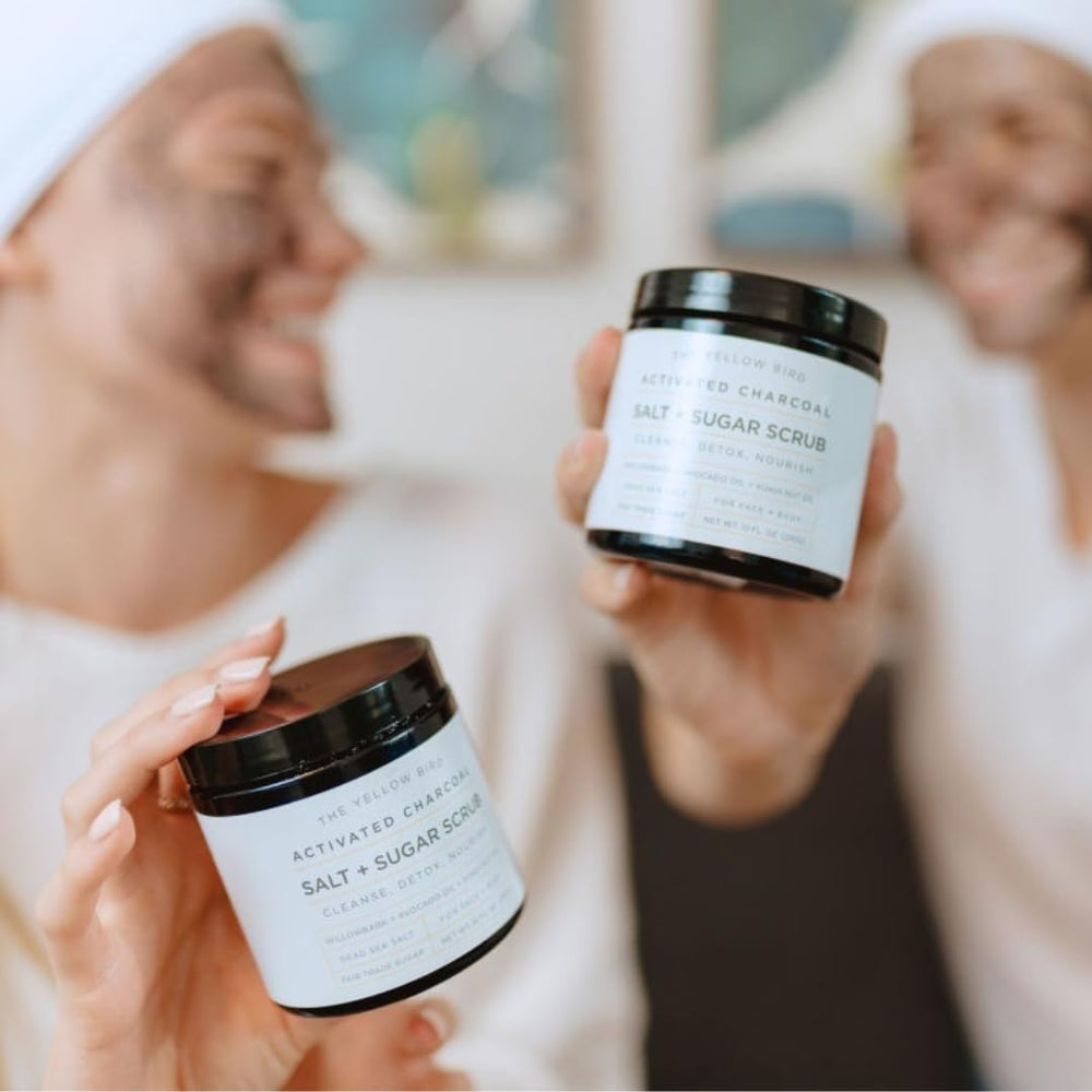 The Yellow Bird activated charcoal scrub being used on feet for cleansing.