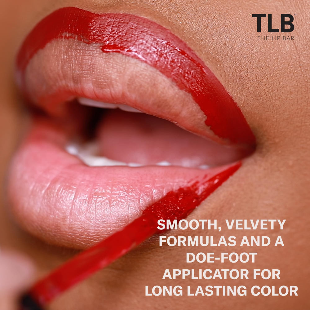 The Lip Bar Savage swatch on arm reveals chocolate red-brown pigment.