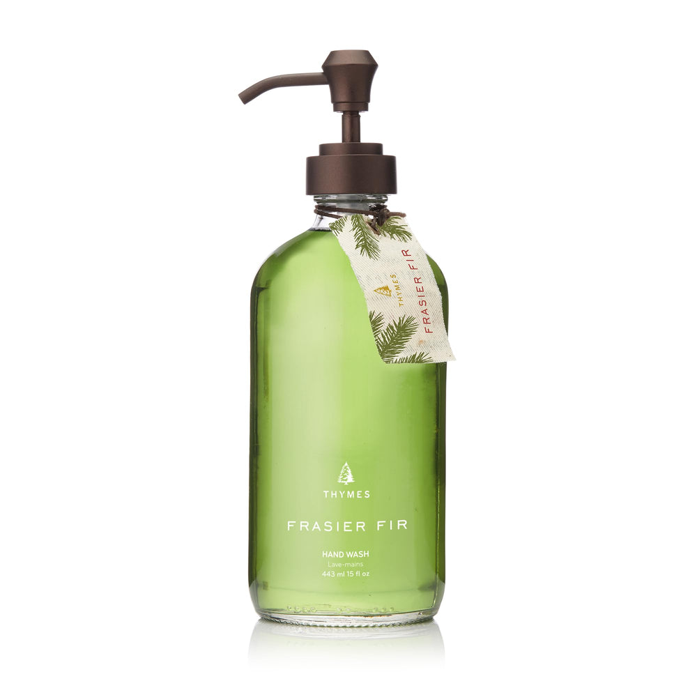 Thymes Frasier Fir hand wash bottle on sink with elegant glass packaging.