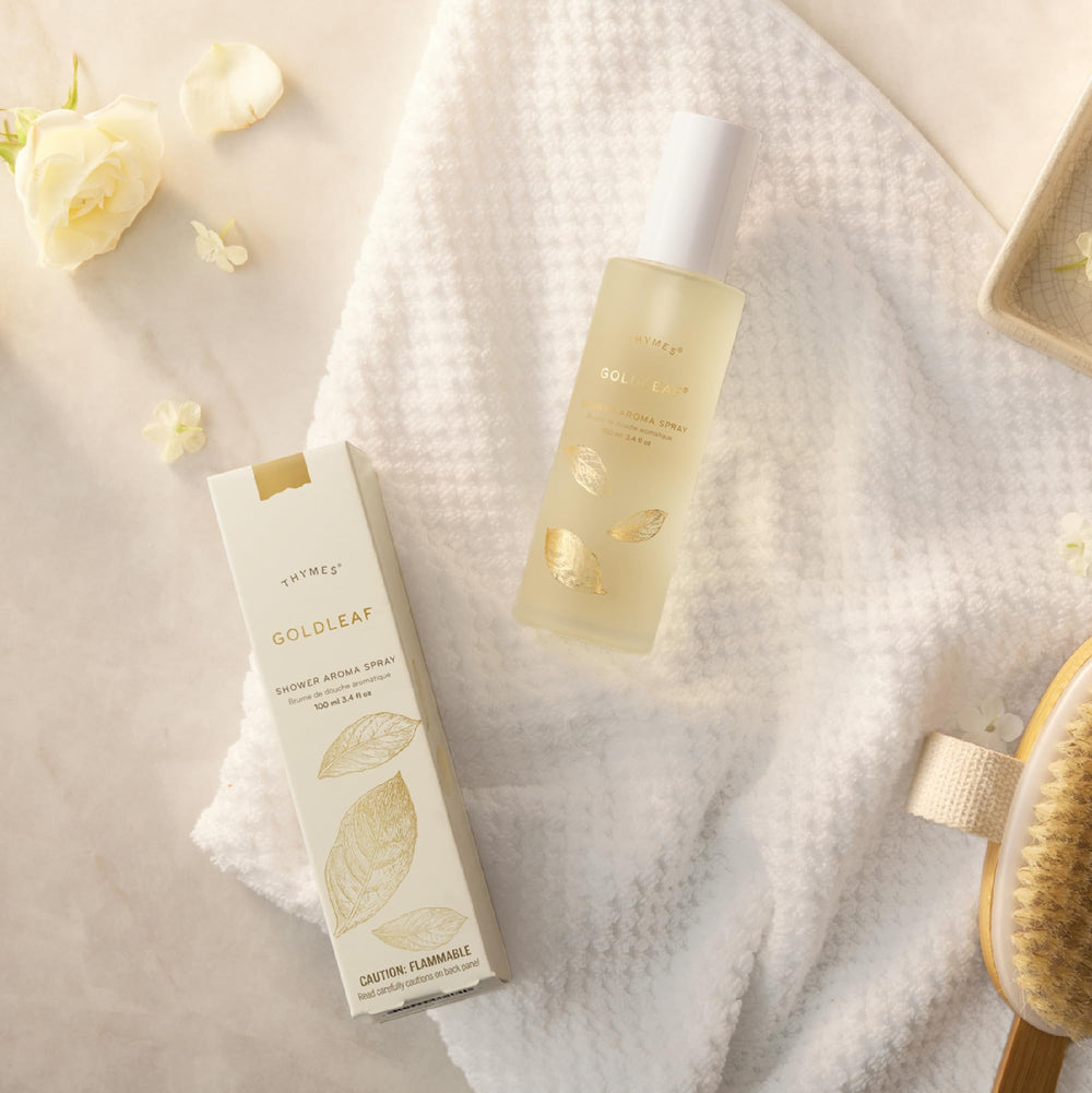 Thymes Goldleaf Shower Spray mist in air creates an uplifting fragrance-rich ambiance.