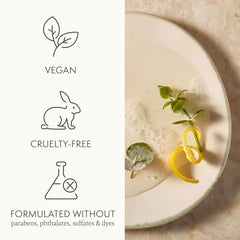Thymes Nourishing Body Cleanser being applied on wet skin in the shower.