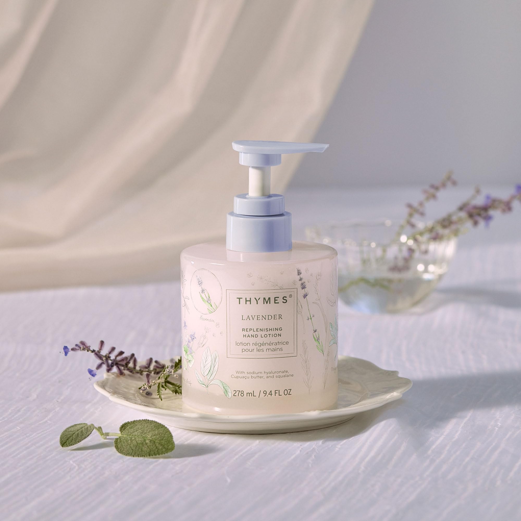 Thymes Replenishing Hand Lotion pump on a clean surface for instant hydration.