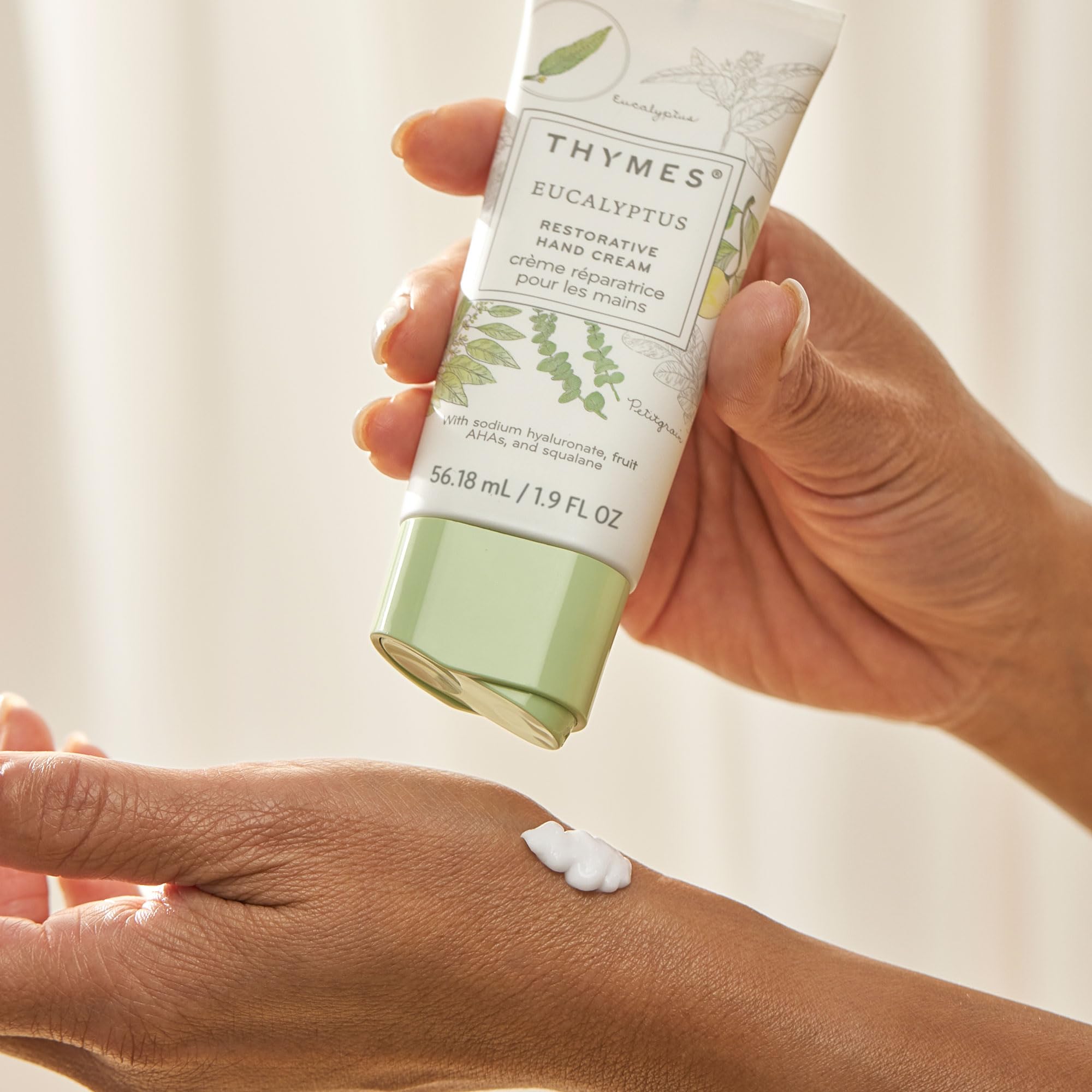 Travel-size Thymes Restorative Hand Cream tube displayed on desk