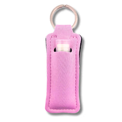TINY SEED pink neoprene lip balm holder keychain attached to a purse.