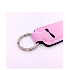Durable neoprene holder by TINY SEED keeps lip balm accessible.