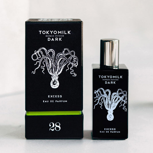TOKYOMILK Dark bottle closeup showing amber resin and oak bark notes for a decadent aura.