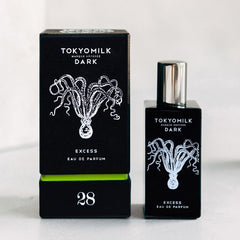 TOKYOMILK Dark bottle closeup showing amber resin and oak bark notes for a decadent aura.
