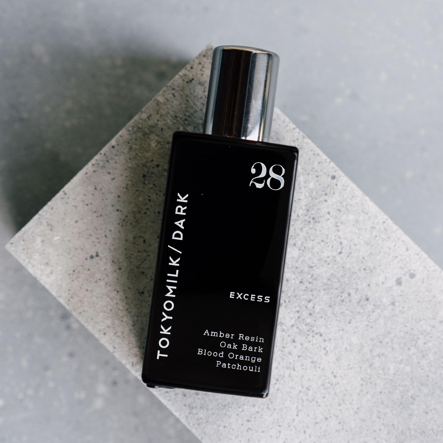 TOKYOMILK Dark compact 1.6 oz bottle suitable for travel and daily wear.