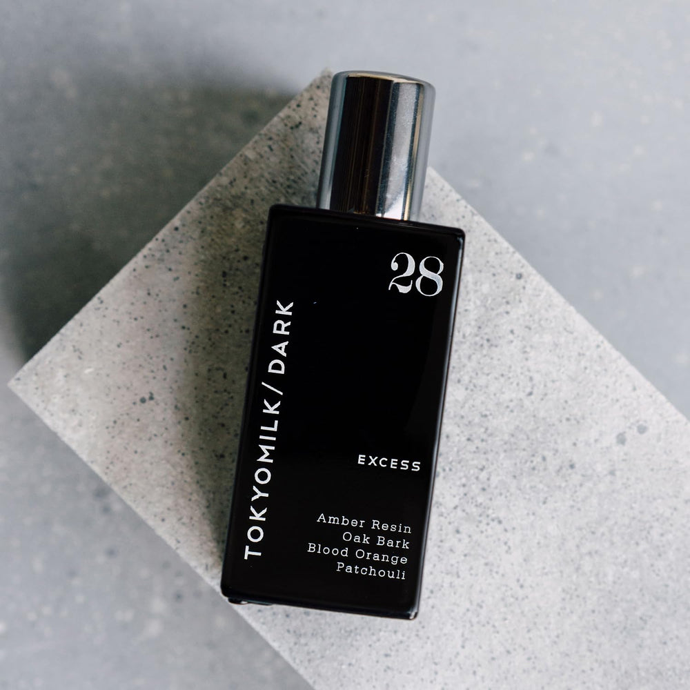 TOKYOMILK Dark compact 1.6 oz bottle suitable for travel and daily wear.
