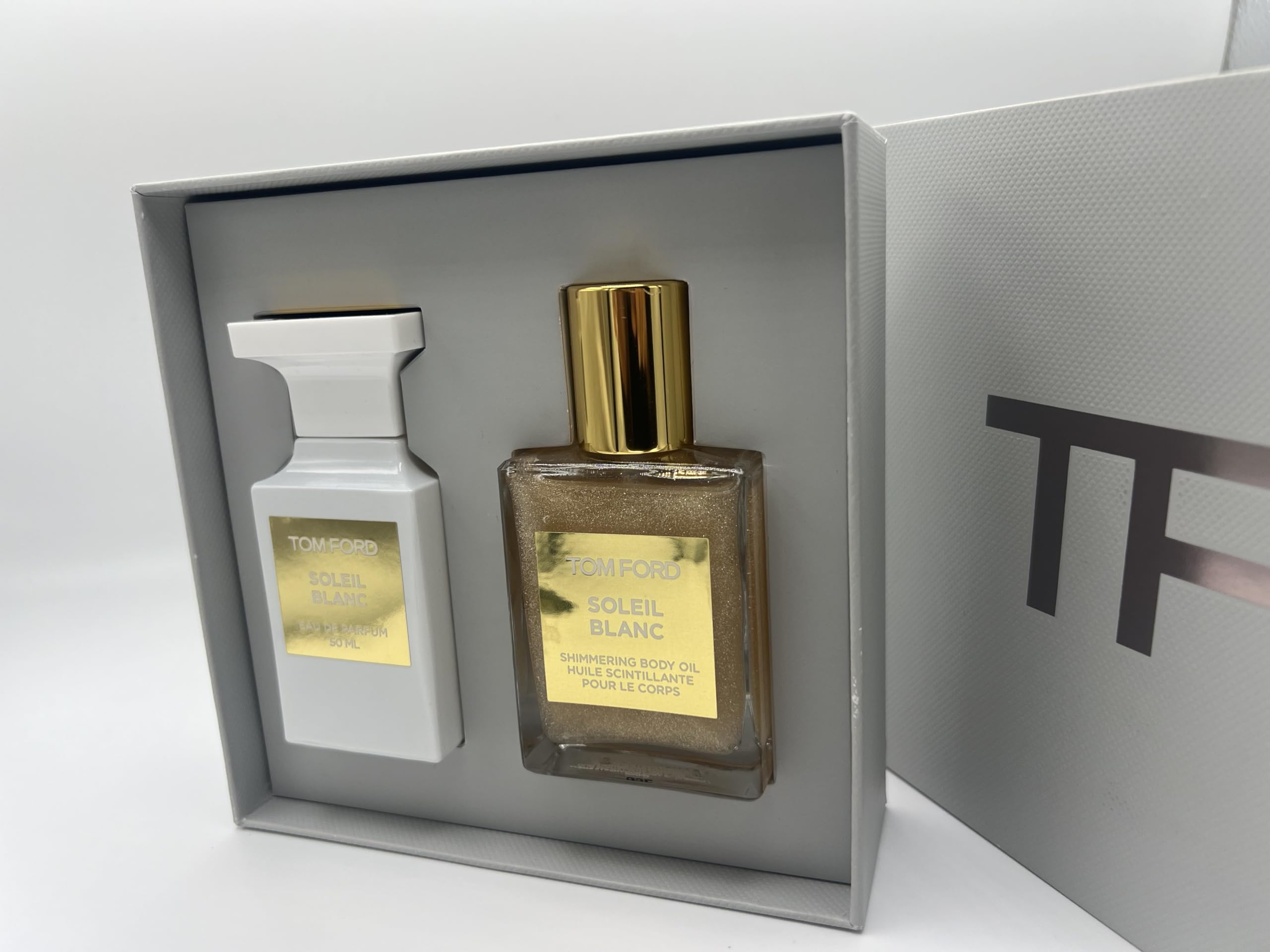 Tom Ford Soleil Blanc shimmering body oil bottle, delivers radiant skin glow.