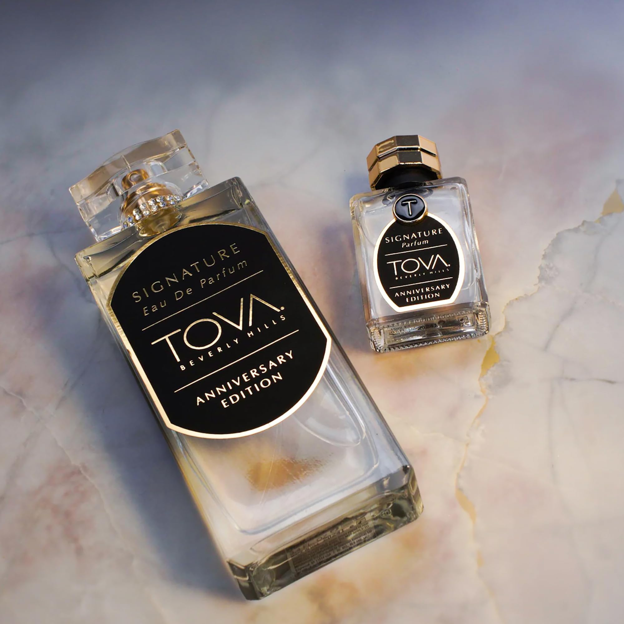 Tova Signature set in hand demonstrates portable luxury for on-the-go scent.