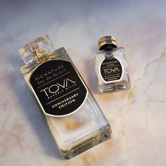 Tova Signature set in hand demonstrates portable luxury for on-the-go scent.