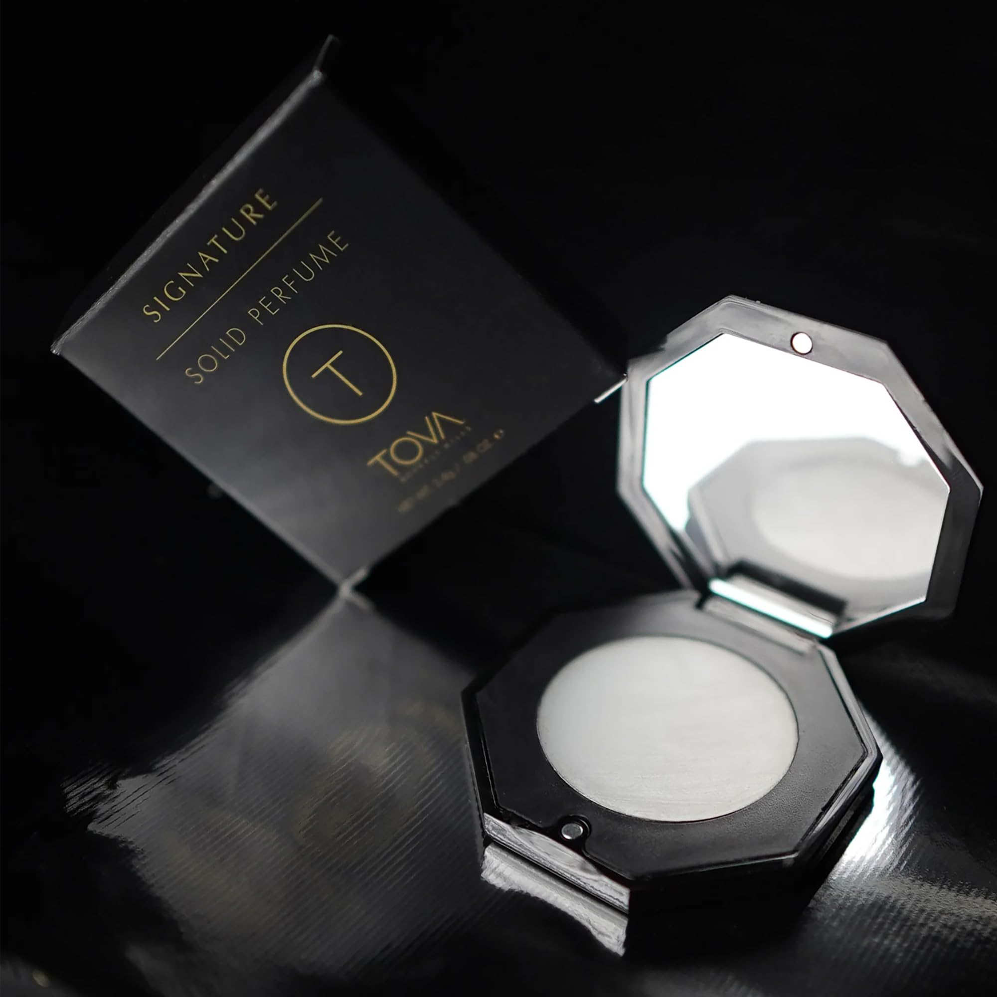 TOVA Signature Solid Perfume Compact applying dab for day-long freshness.