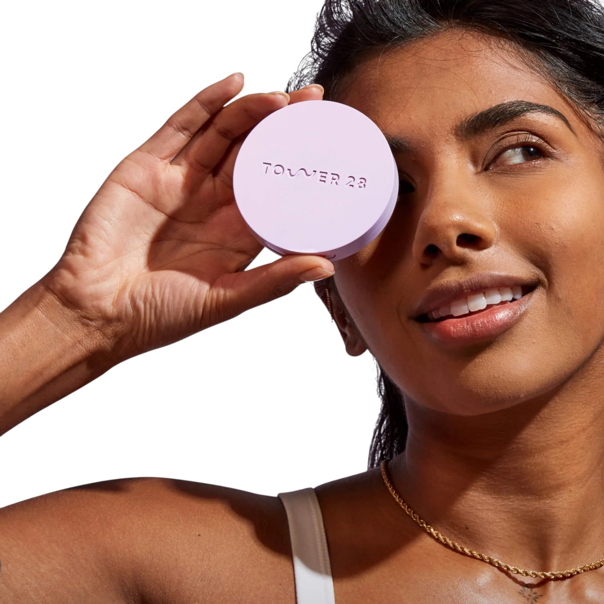 Close-up of Tower28 GetSet pink powder blurring pores for a soft matte look.