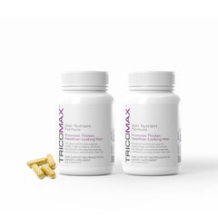 Tricomax hair growth bottle on a clean surface showing capsules for hair support.